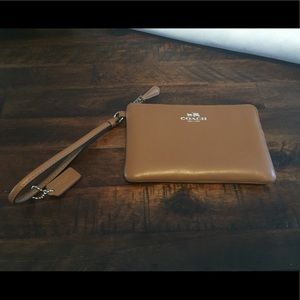 Coach Wristlet in the color Saddle